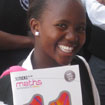 Pupil at Bhukulone Secondary School with a new 10ticks workbook